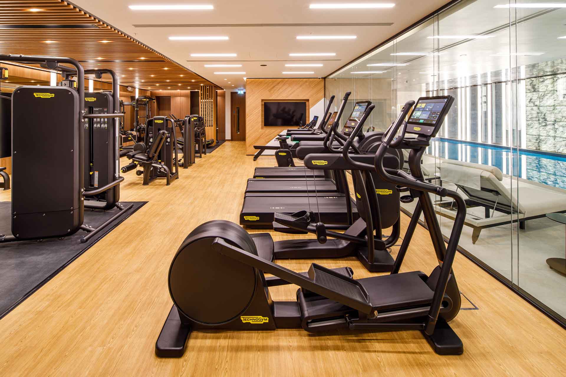 Gym with view of indoor pool