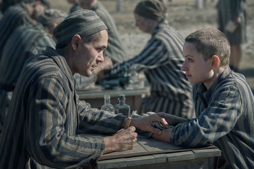Jonah Hauer-King as Lali Sokolov meets Anna Próchniak as Gita Furman in The Tattooist of Auschwitz.