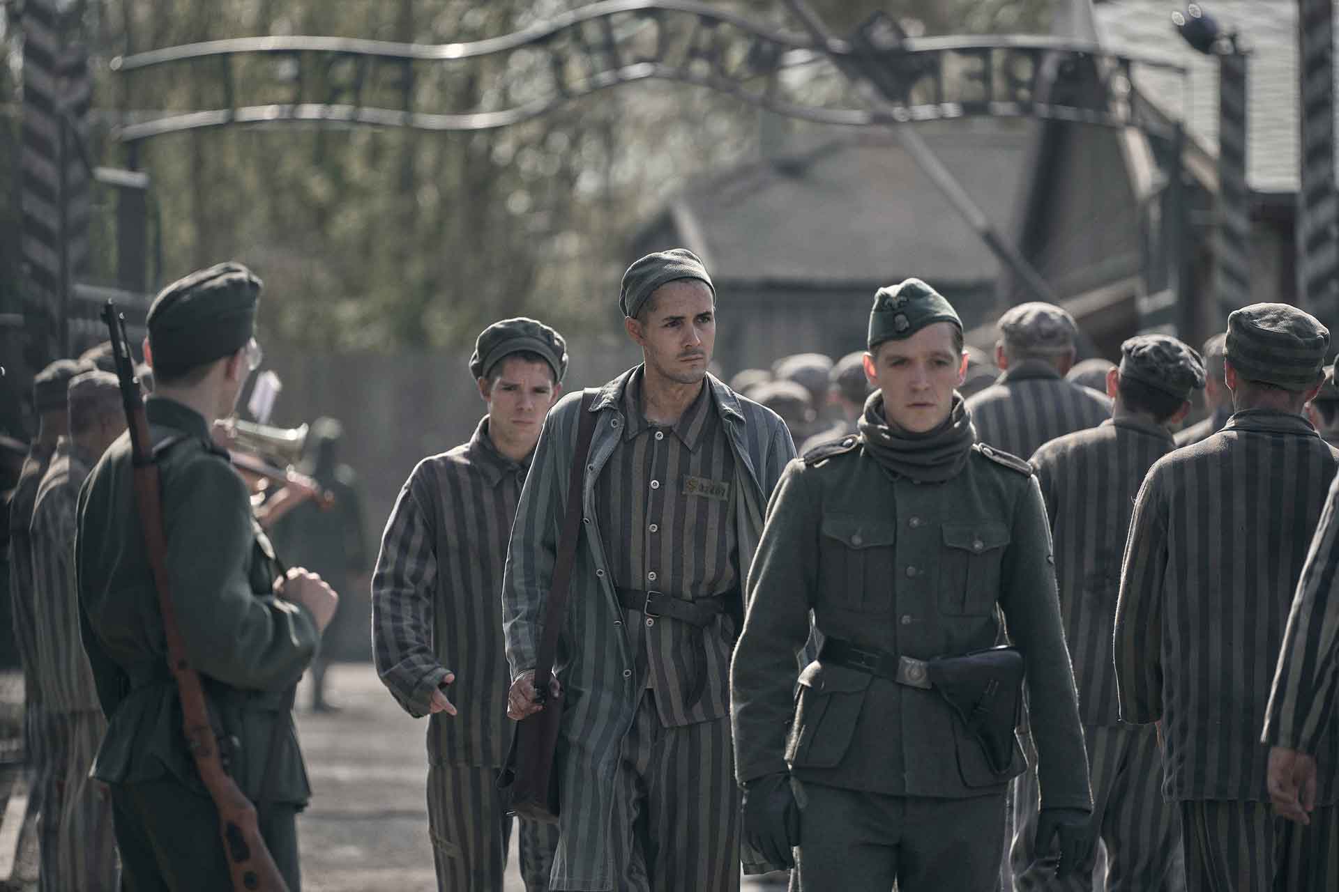 Jonah Hauer-King playing Lali Sokolov, walking through Auschwitz with German-born actor Jonas Nay playing Nazi officer Stefan Baretzk.