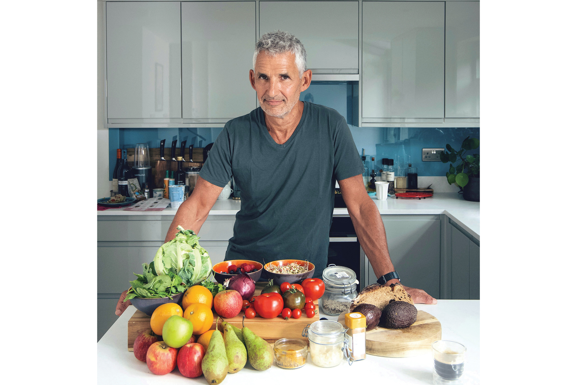 Tim Spector in kitchen with food on table in front