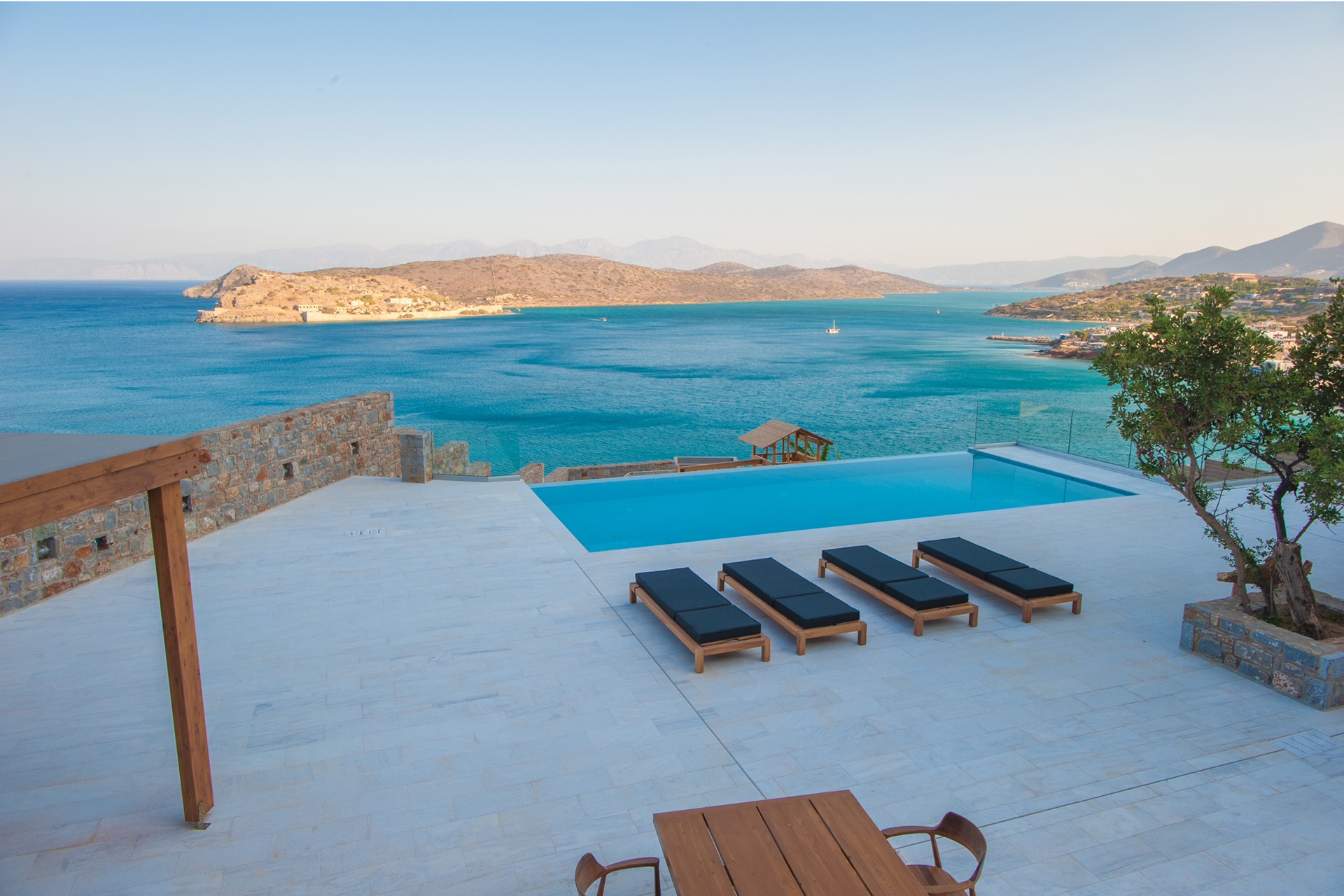 Sun loungers and an infinity pool overlooking the sea