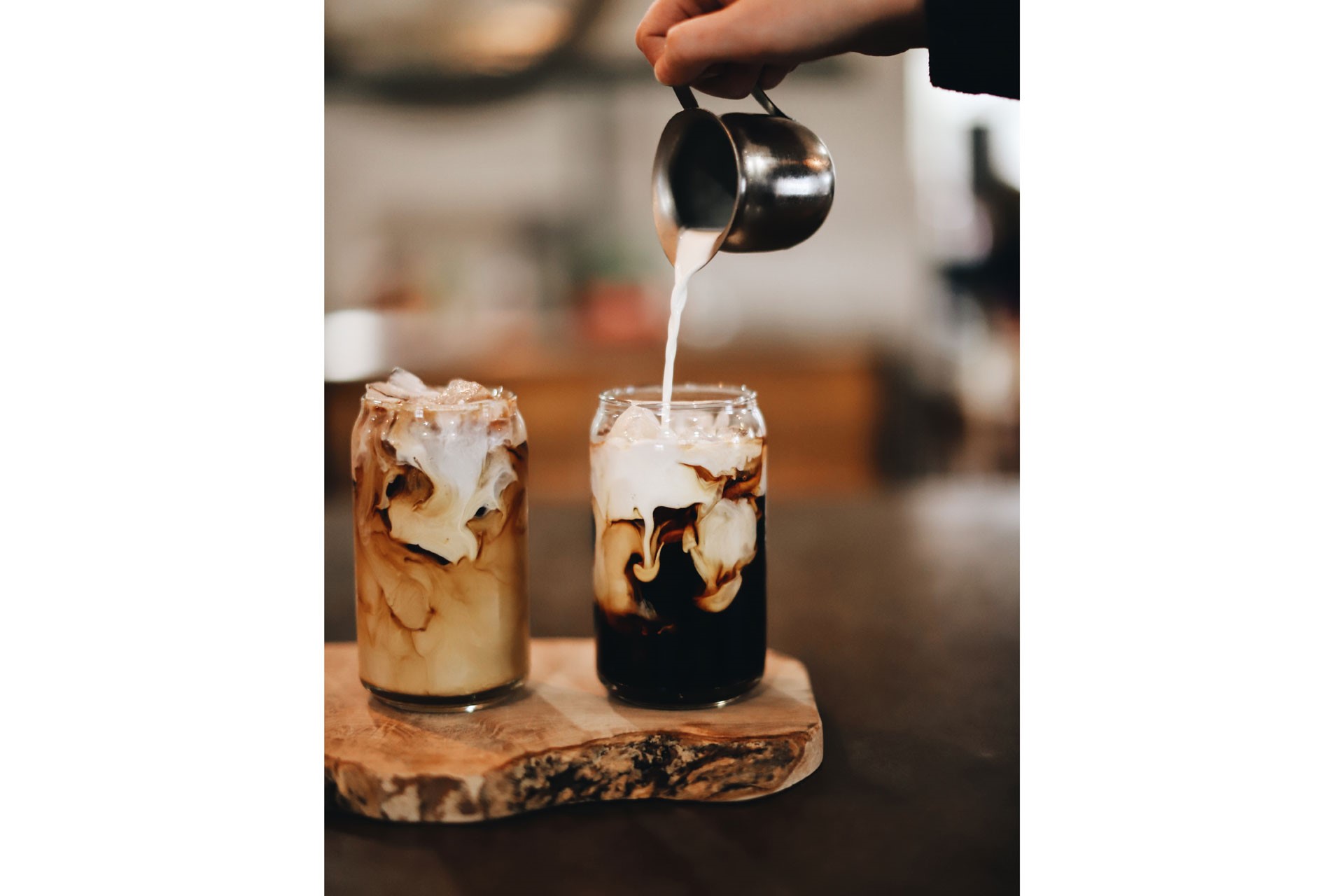 Milk being poured into cold brew coffee