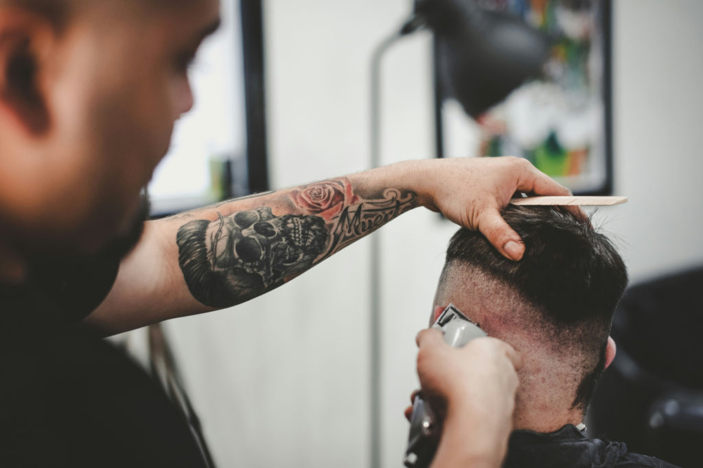 Man getting hair cut by barber | Caesar haircut