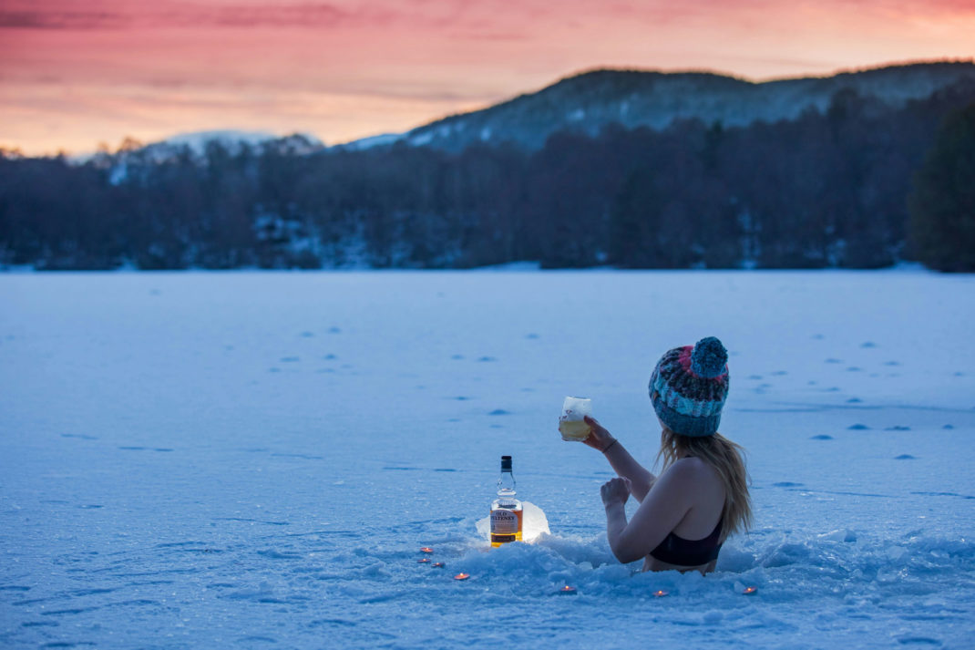 Woman swimming in a loch in Scotland