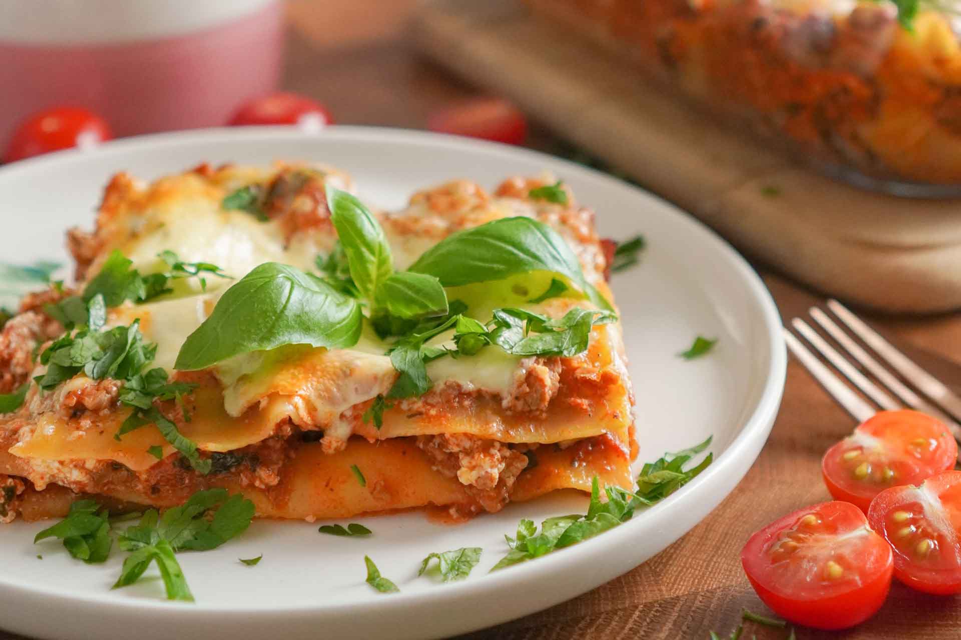 plate of lasagne garnished with basil