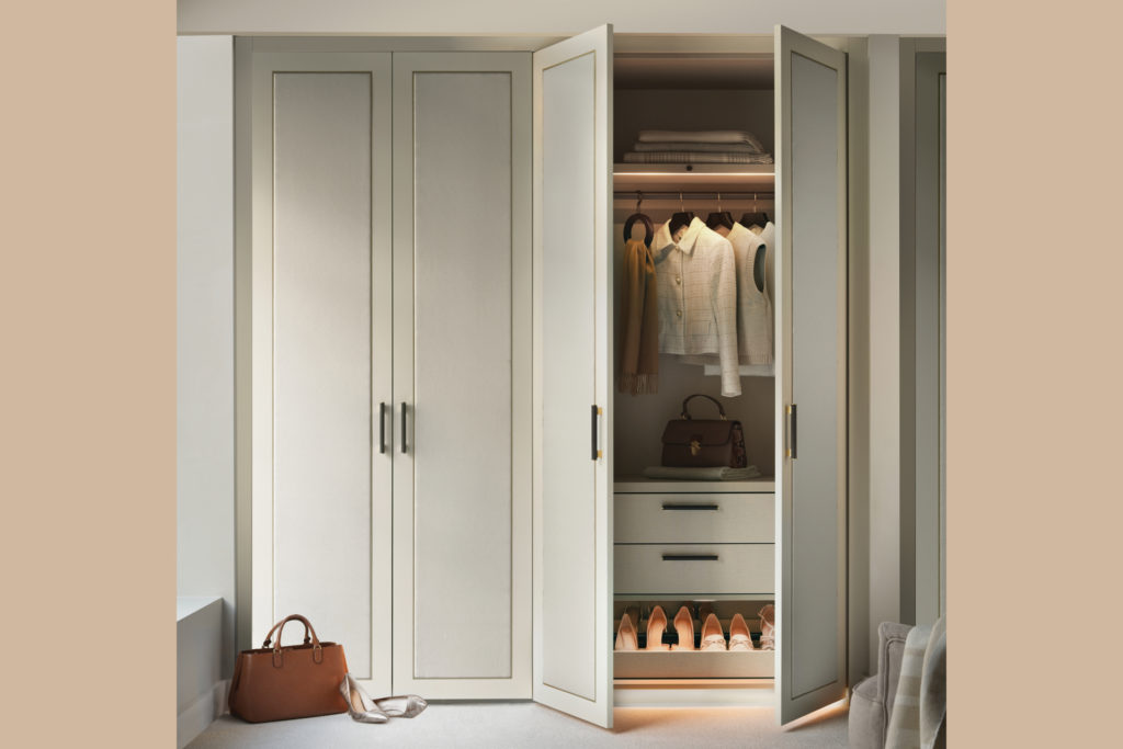 neatsmith white wardrobe with door ajar to see clothes hanging inside