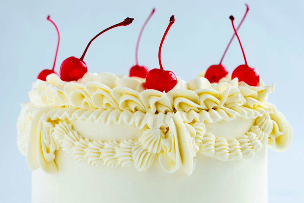 Buttercream cake with cherries on top