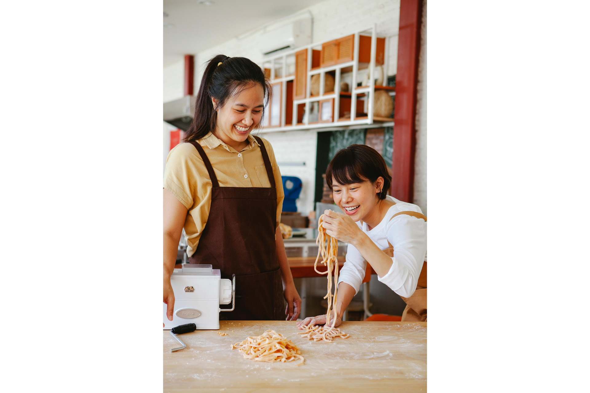 Two people making pasta together