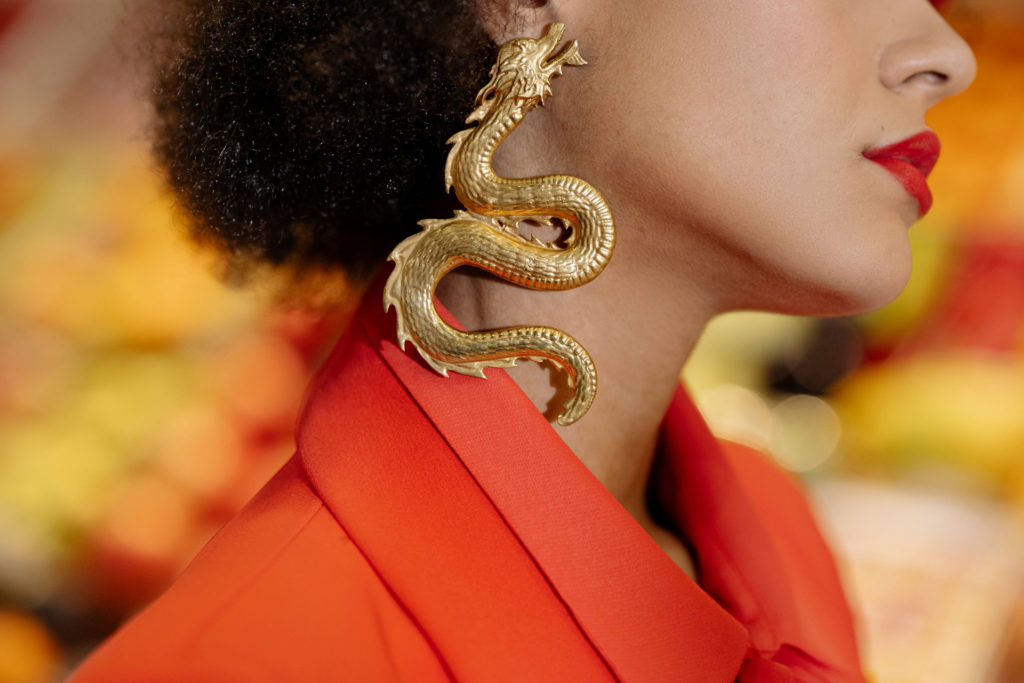 A woman wearing a dragon earring