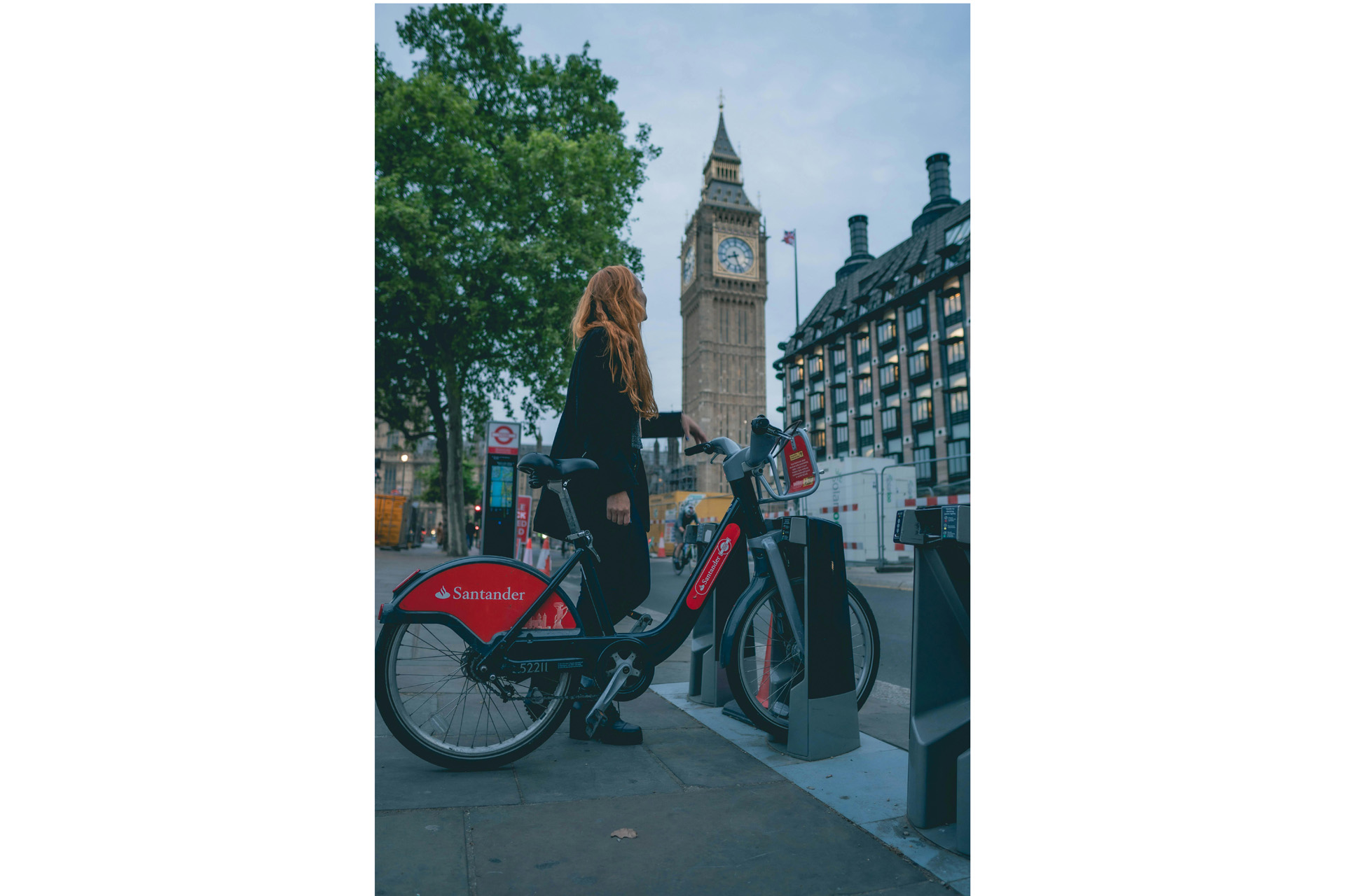 A woman stood with a bike in front of Big Ben