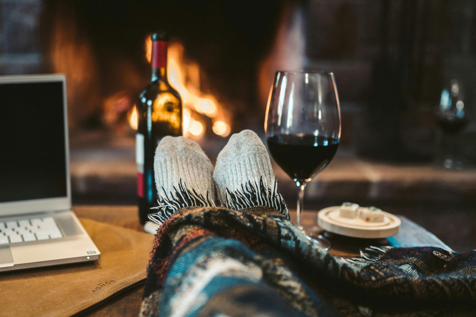 Feet by the fire with a glass of red wine