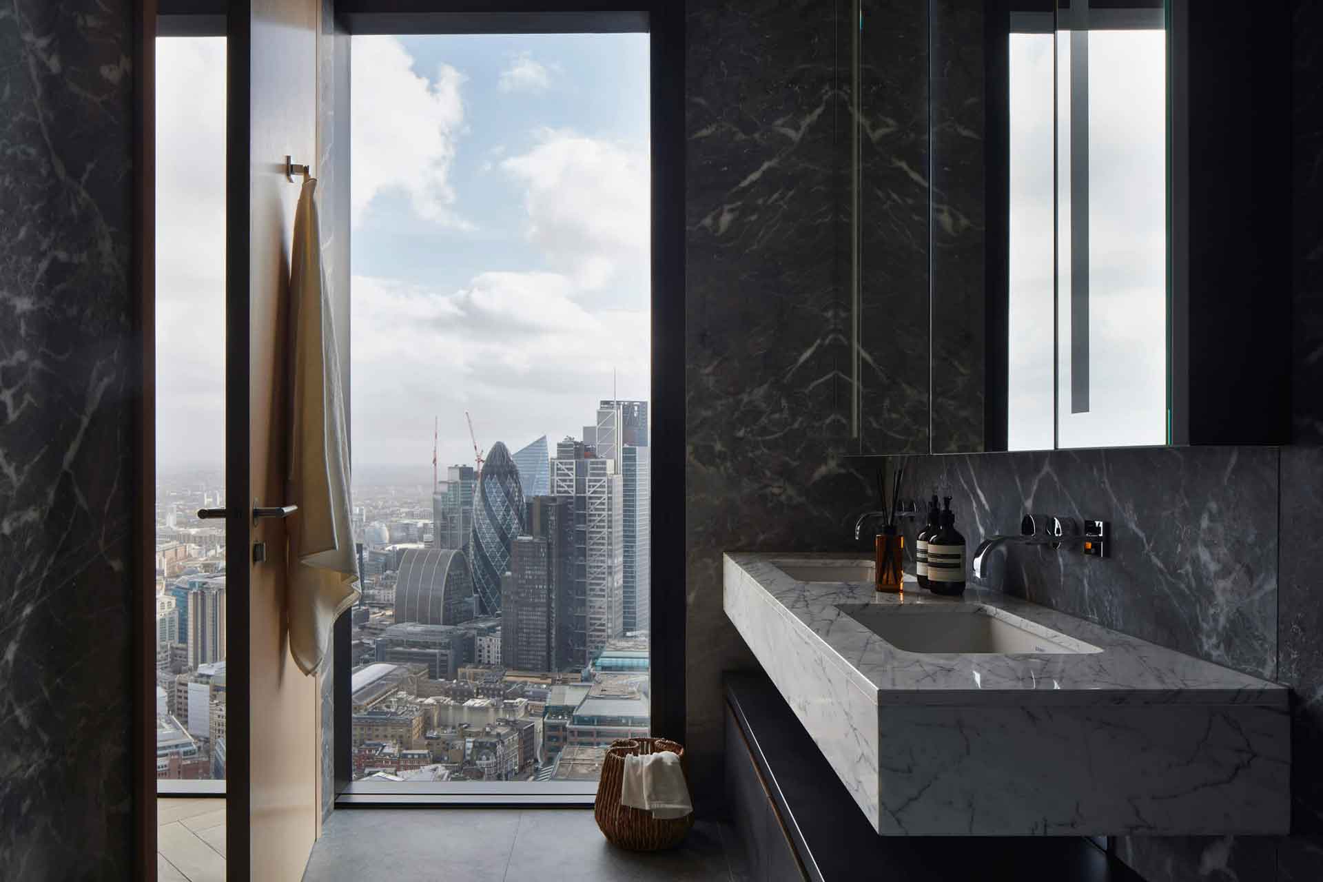 Bathroom with sink vanity, Aesop soaps and views of the London skyline.