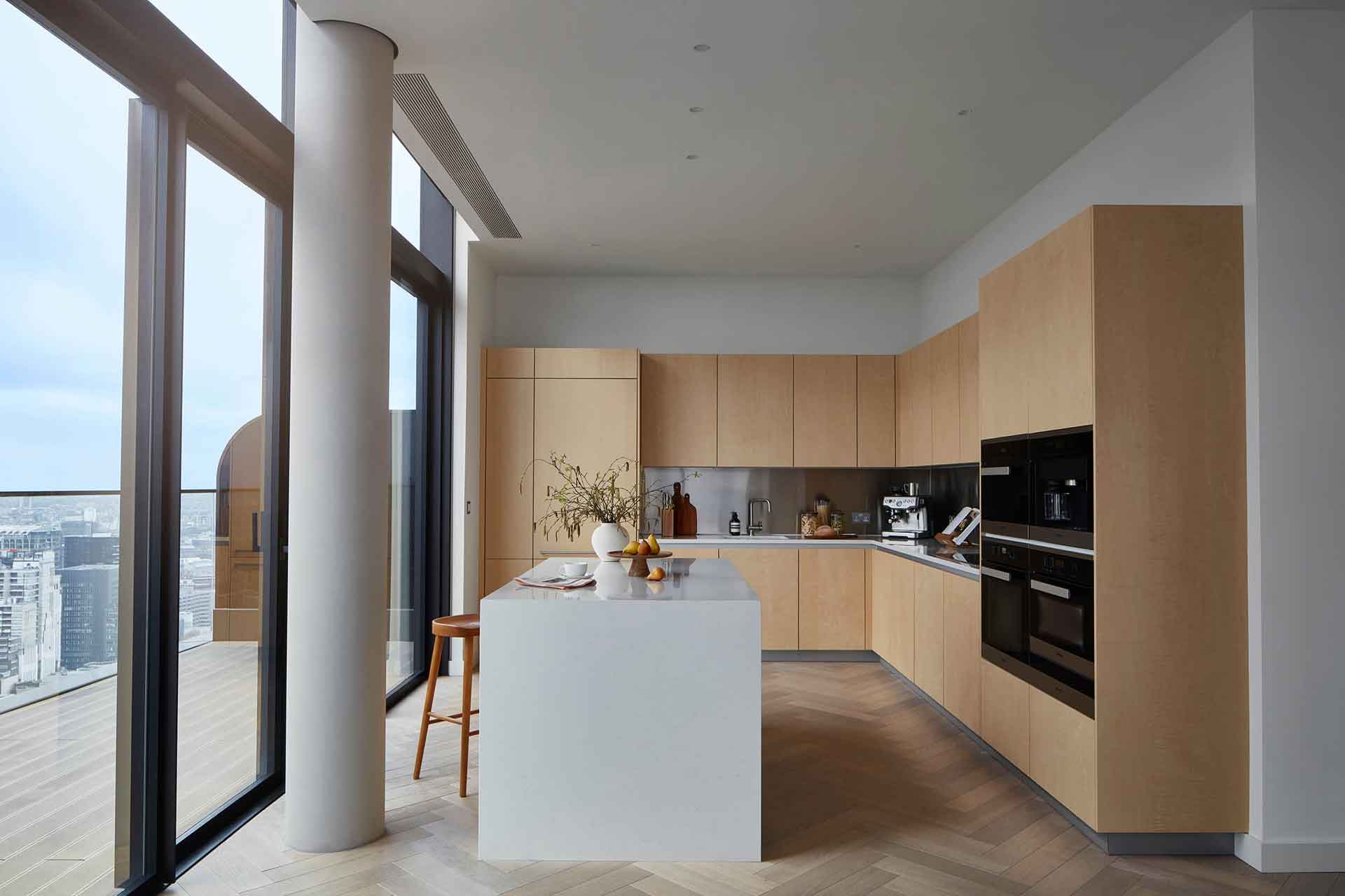 Kitchen with light wooden cabinets and a white island.