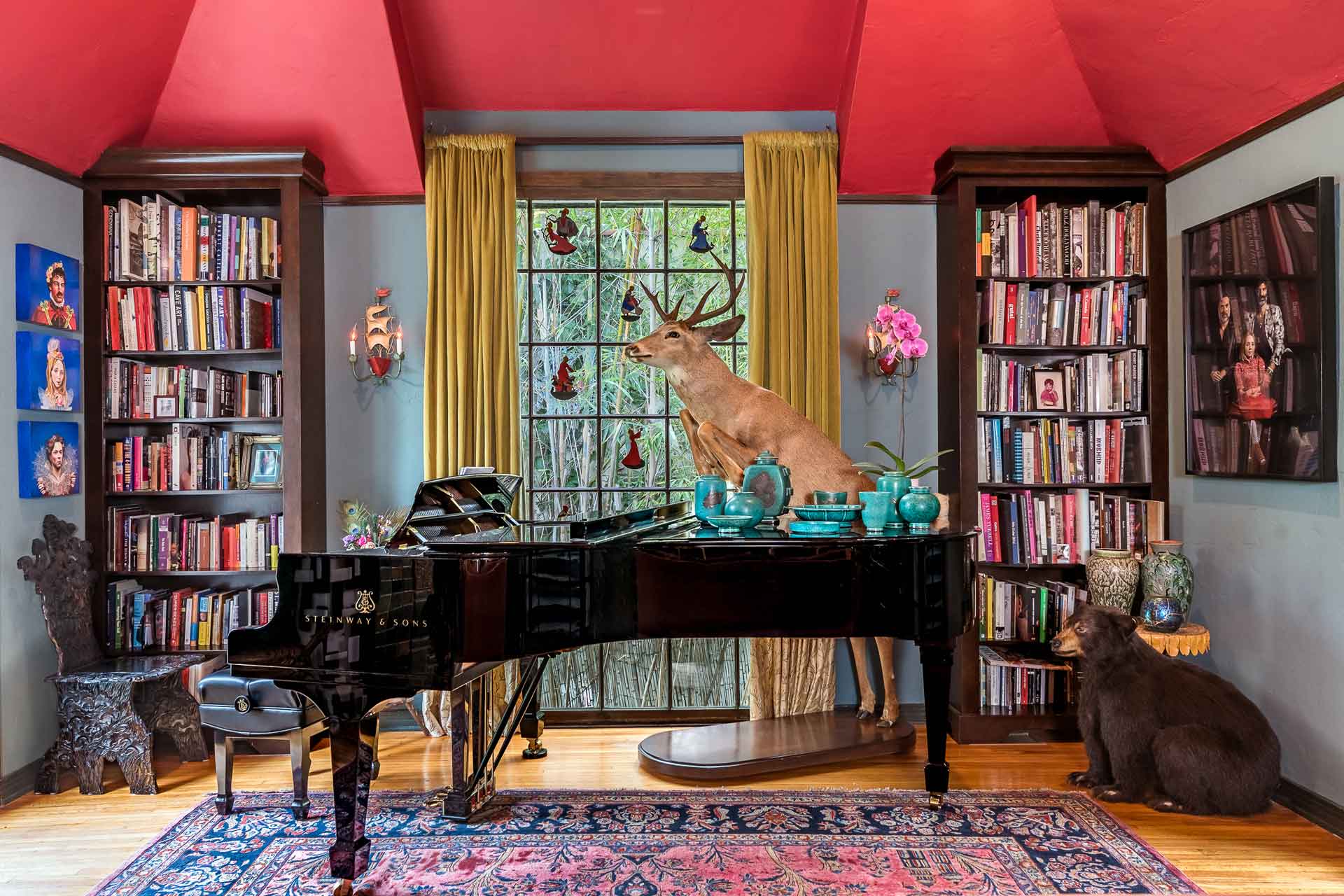 Music room with red ceilings and a grand piano.