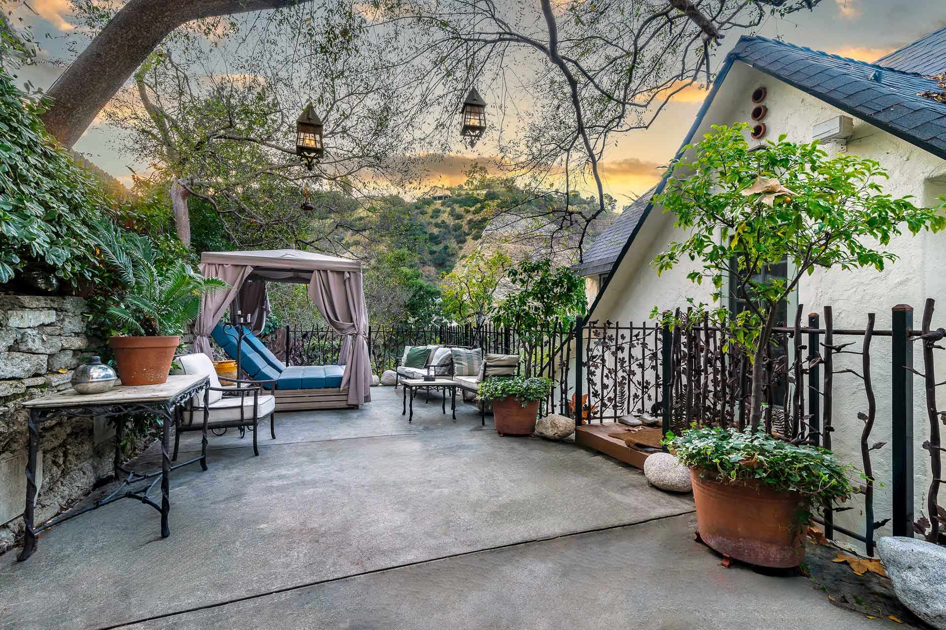 Outdoor terrace with sun loungers, plants, and views over Laurel Canyon.