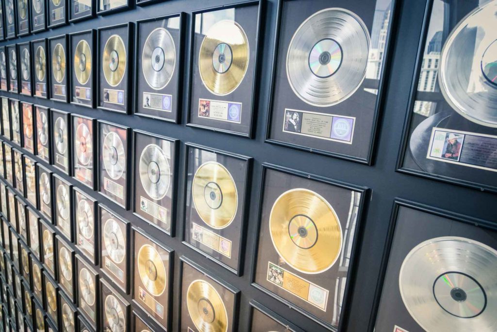 Wall of gold and silver music record plaques.
