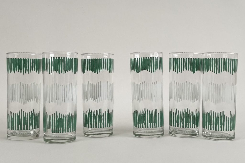 Clear highball glasses with a green and white etched design