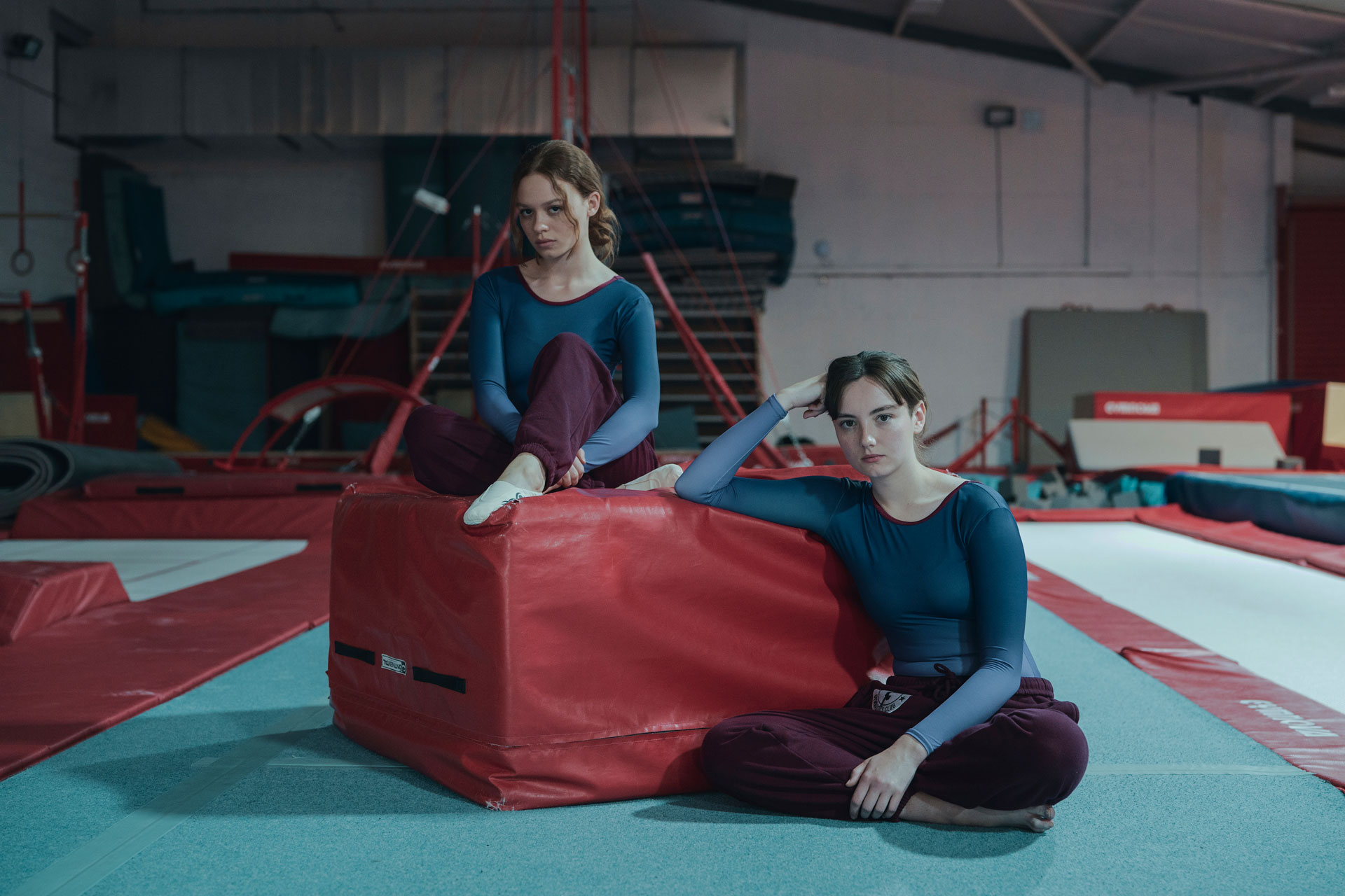 Gymnasts sitting in a gymnasium in 'The Gathering'