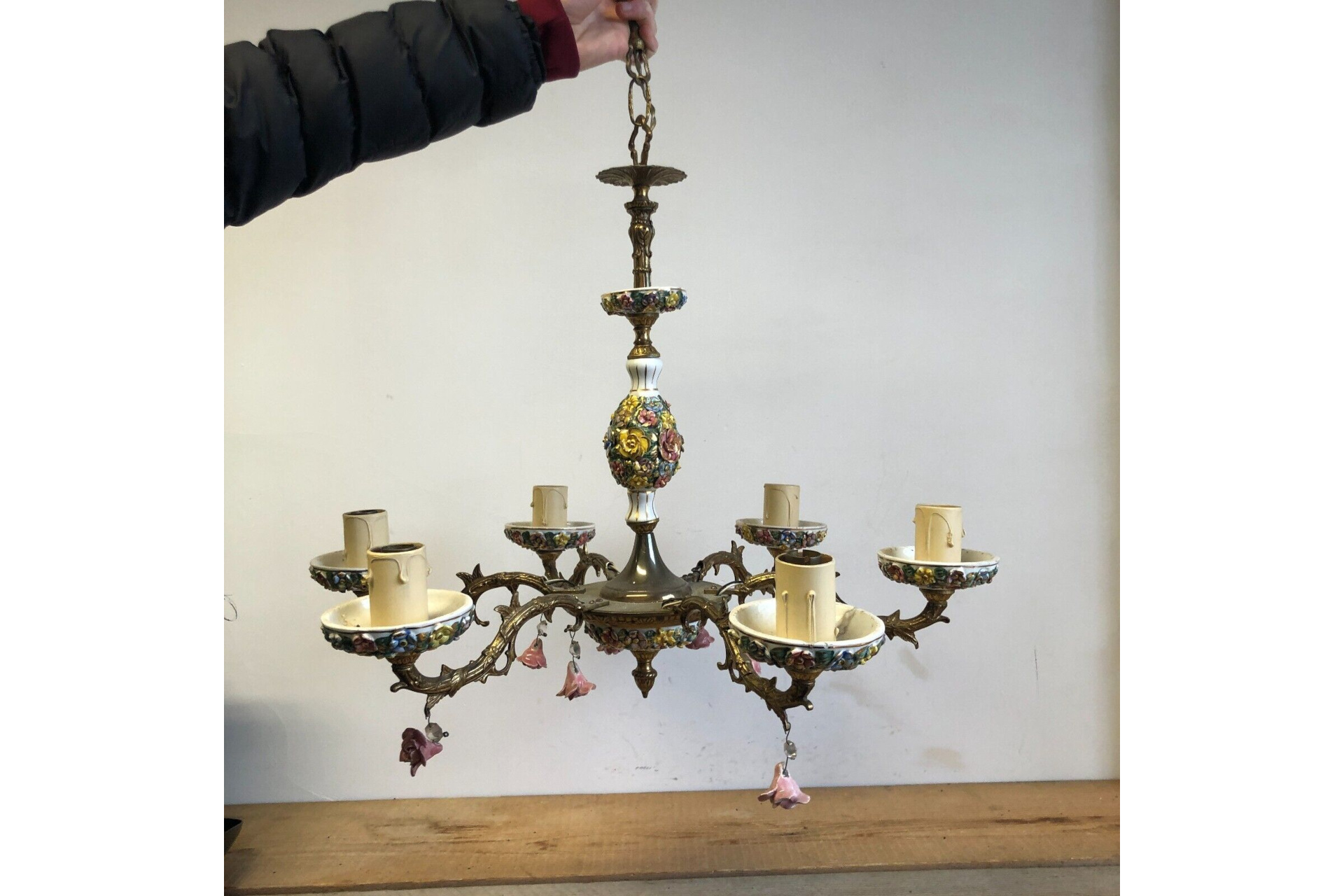 Hand holding up chandelier