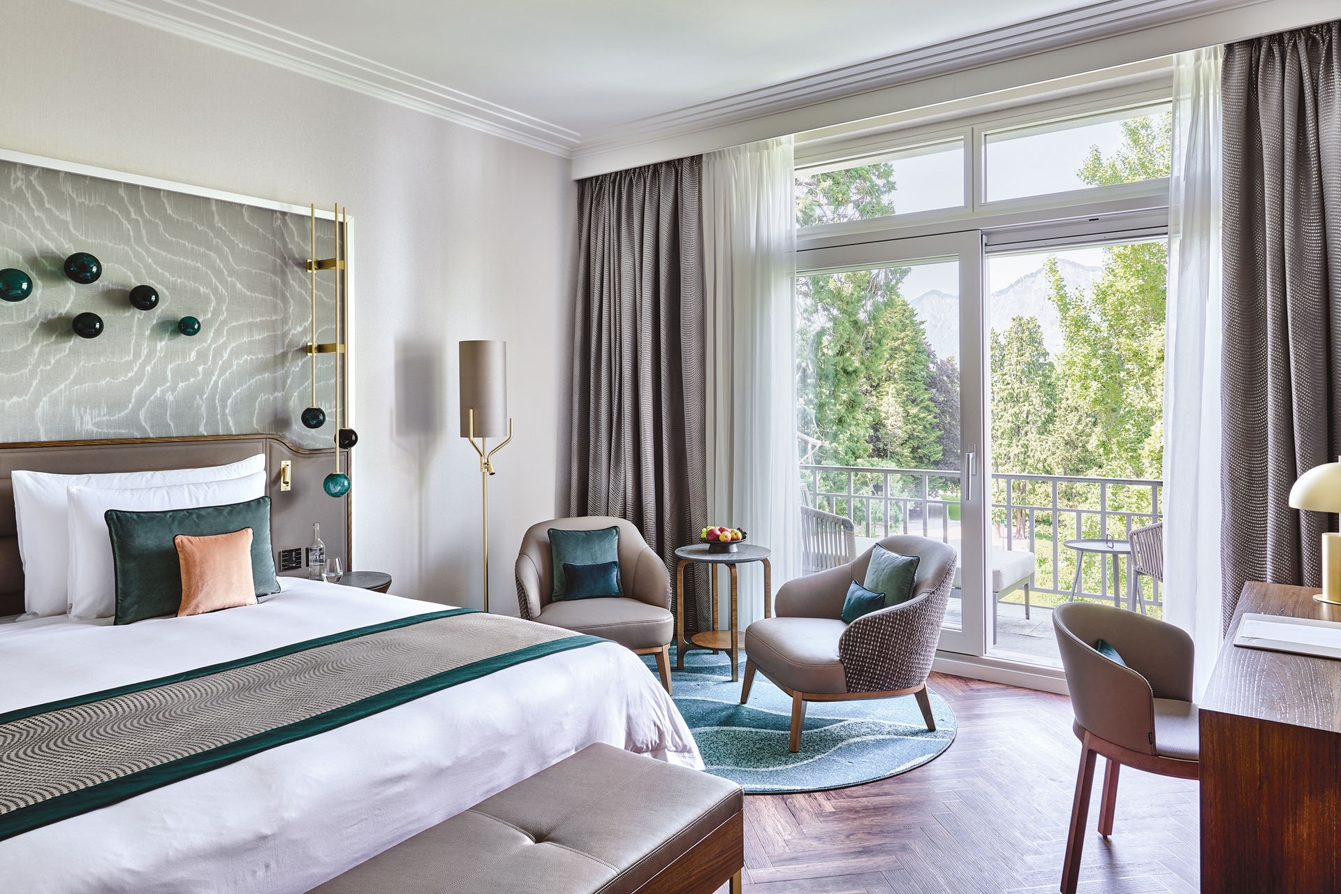 Bedroom with white and green colour palette and a view of the mountains.