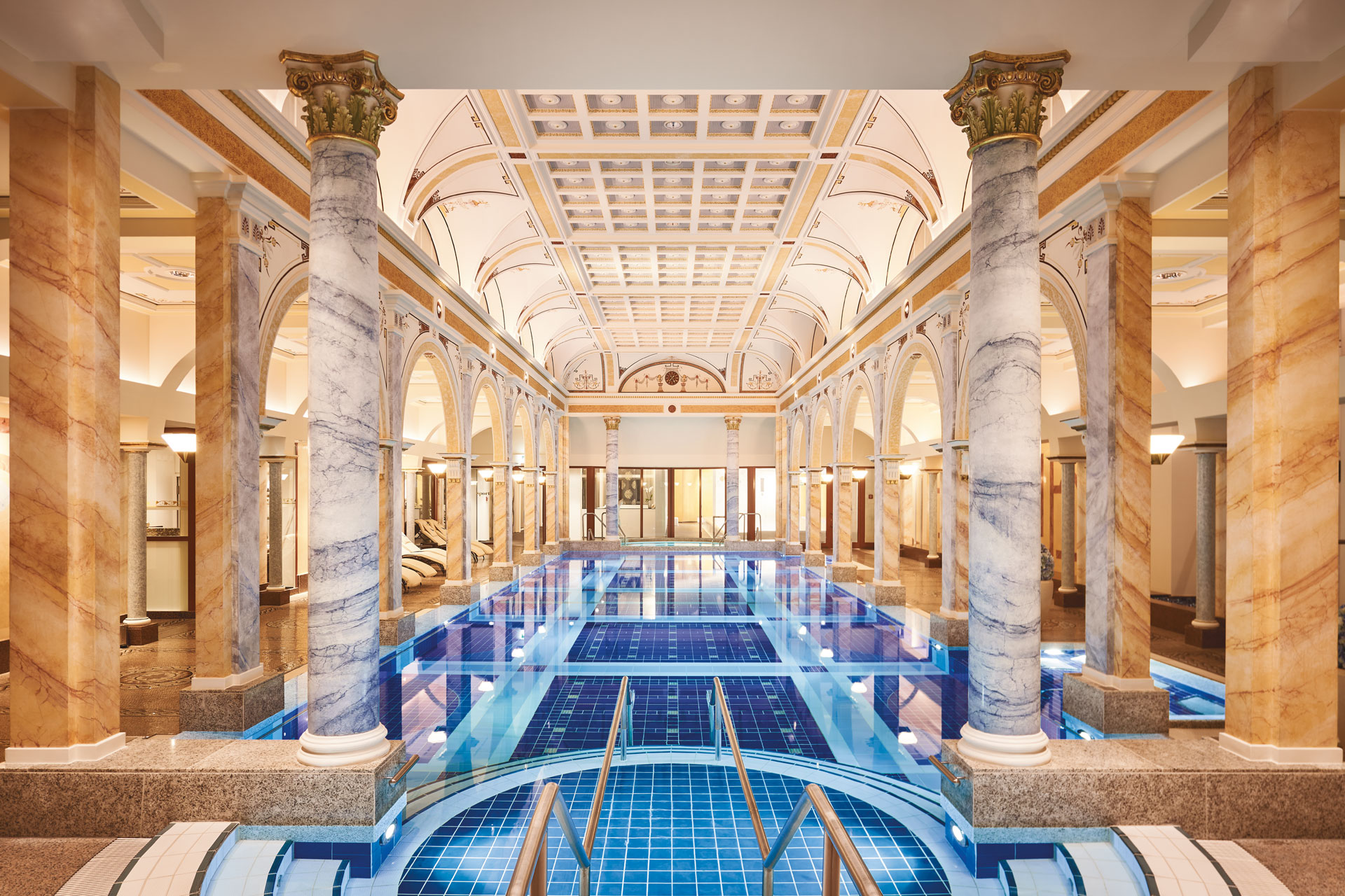 Thermal spa with marble pillars and a chandelier.