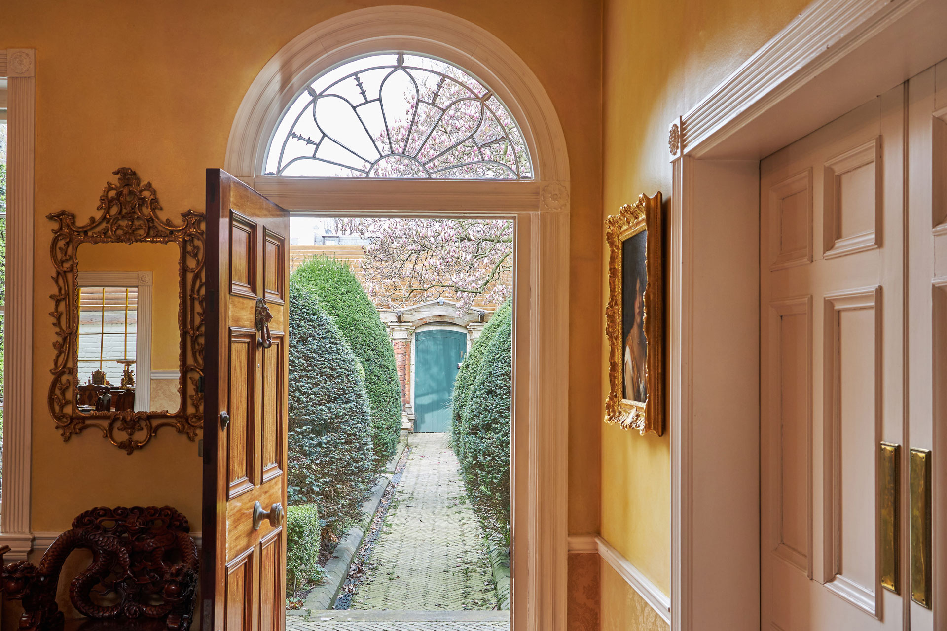 Hallway with arched glass window above the doorway.