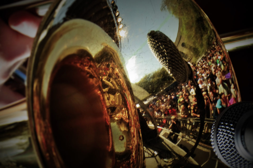 Crowd reflect in trombone New Orleans festival