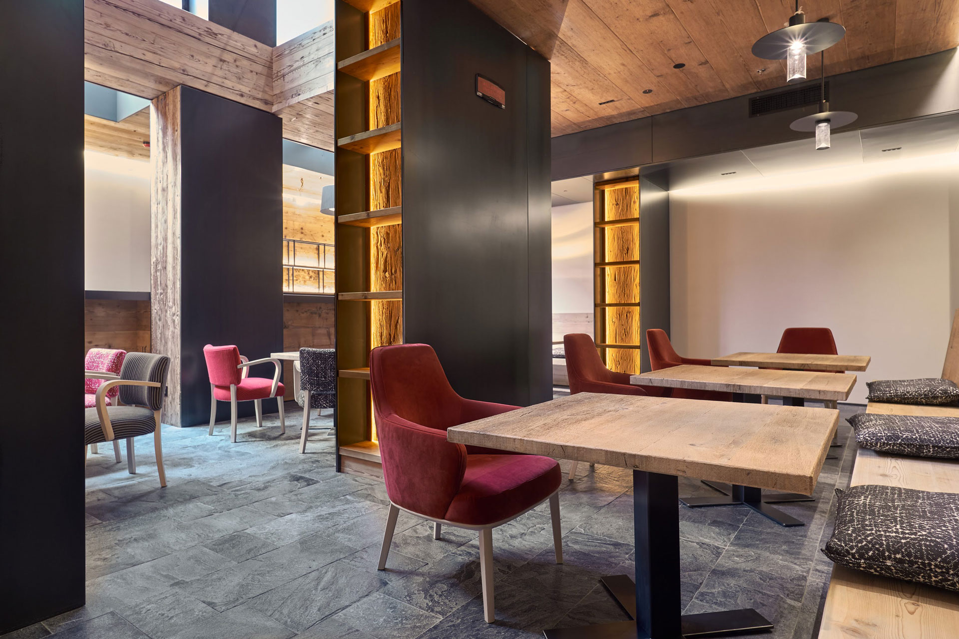 Wood-panelled dining room with plush red chair.