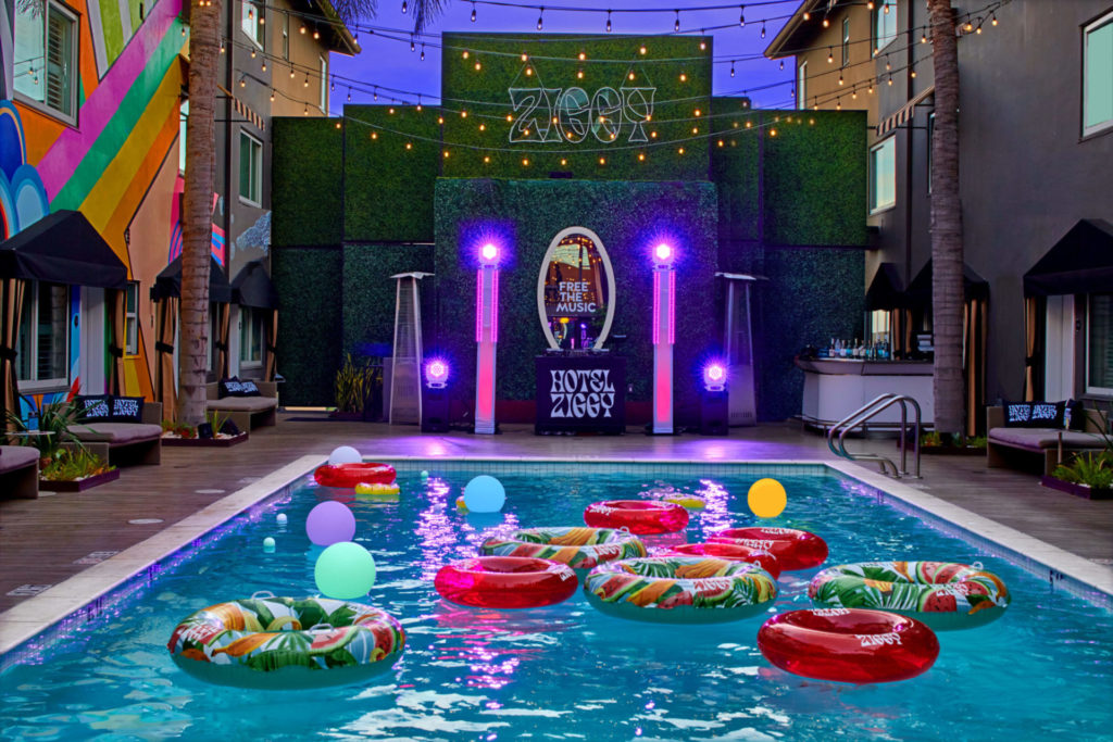 Outdoor pool with blow-up rings and neon lights