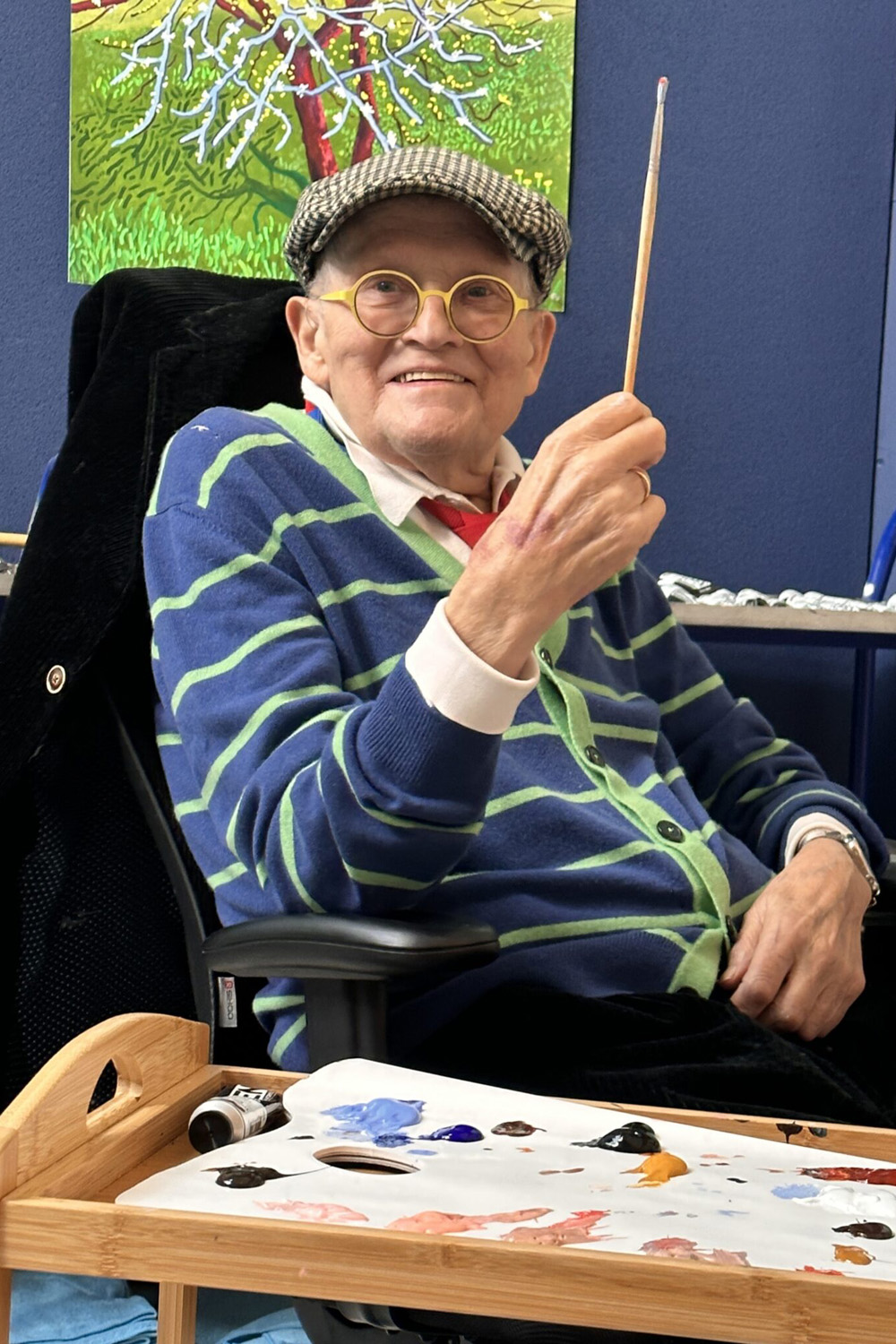 David Hockney holding a paint brush