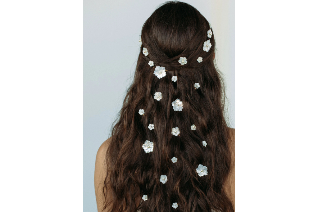 Back of woman's head with white floral hair clips