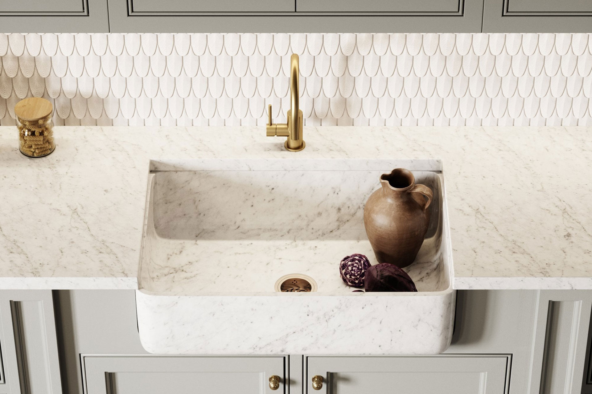 White marble integrated sink with grey shaker style kitchen cupboards and a white scalloped tile backsplash behind.l