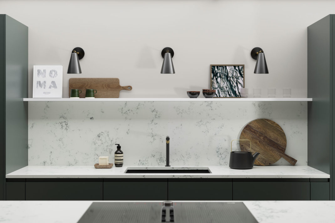 Kitchen with black cabinets and white worktops, with a white island.