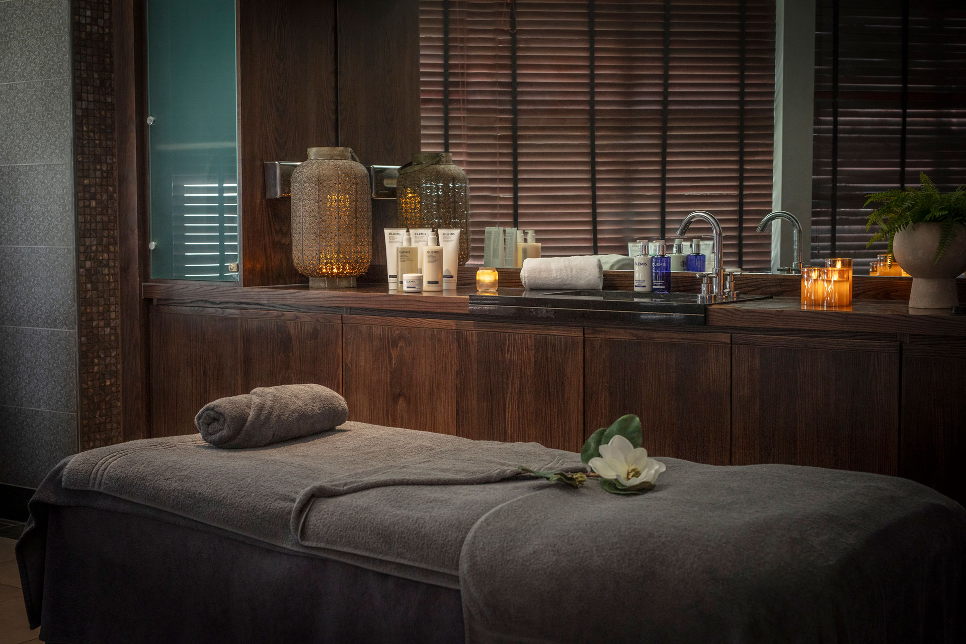 Spa with candles and treatment bed