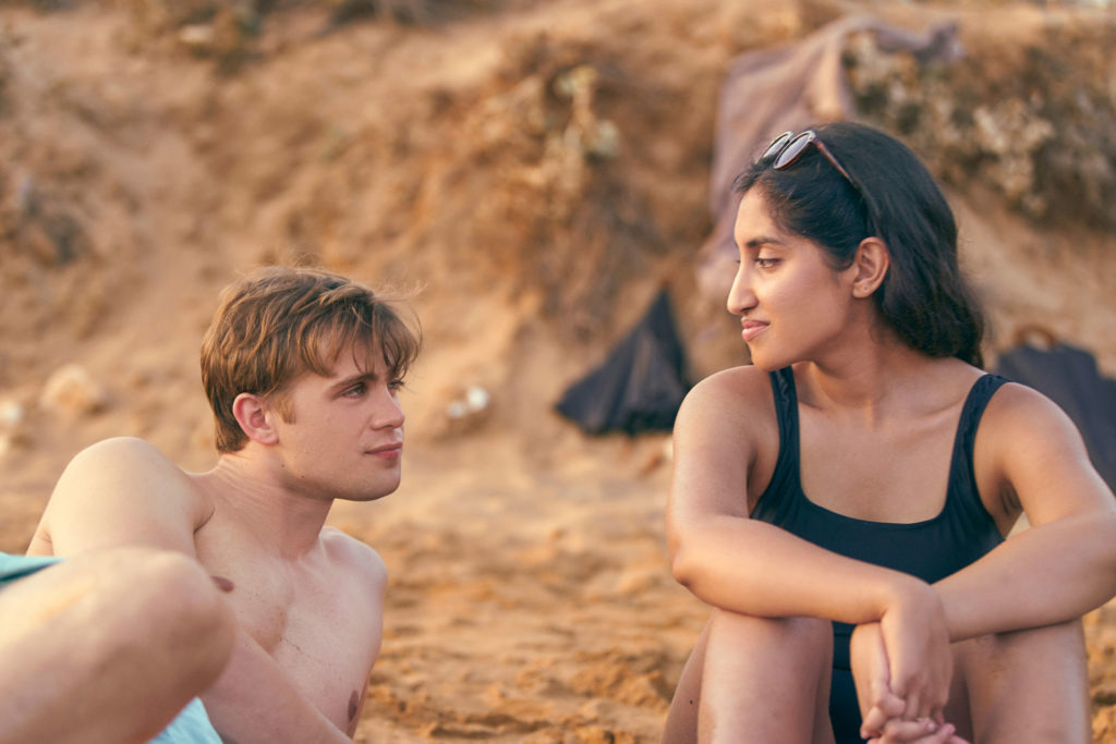 Leo Woodall and Ambika Mod on the beach in Netflix's One Day.