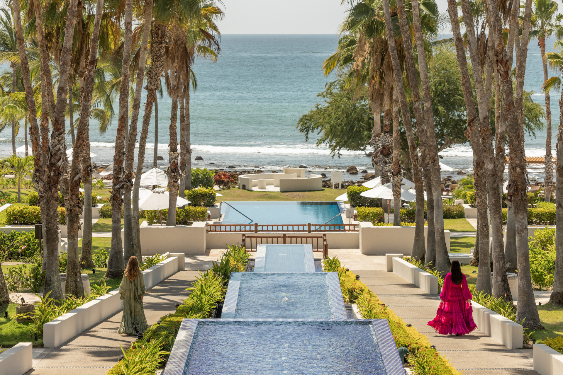 Woman walking down stairs either side of water feature outdoors