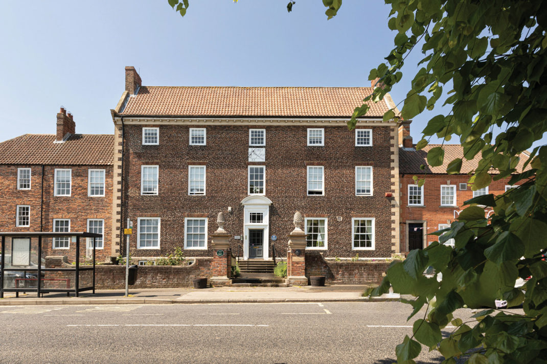 Georgian manor house with side extension.