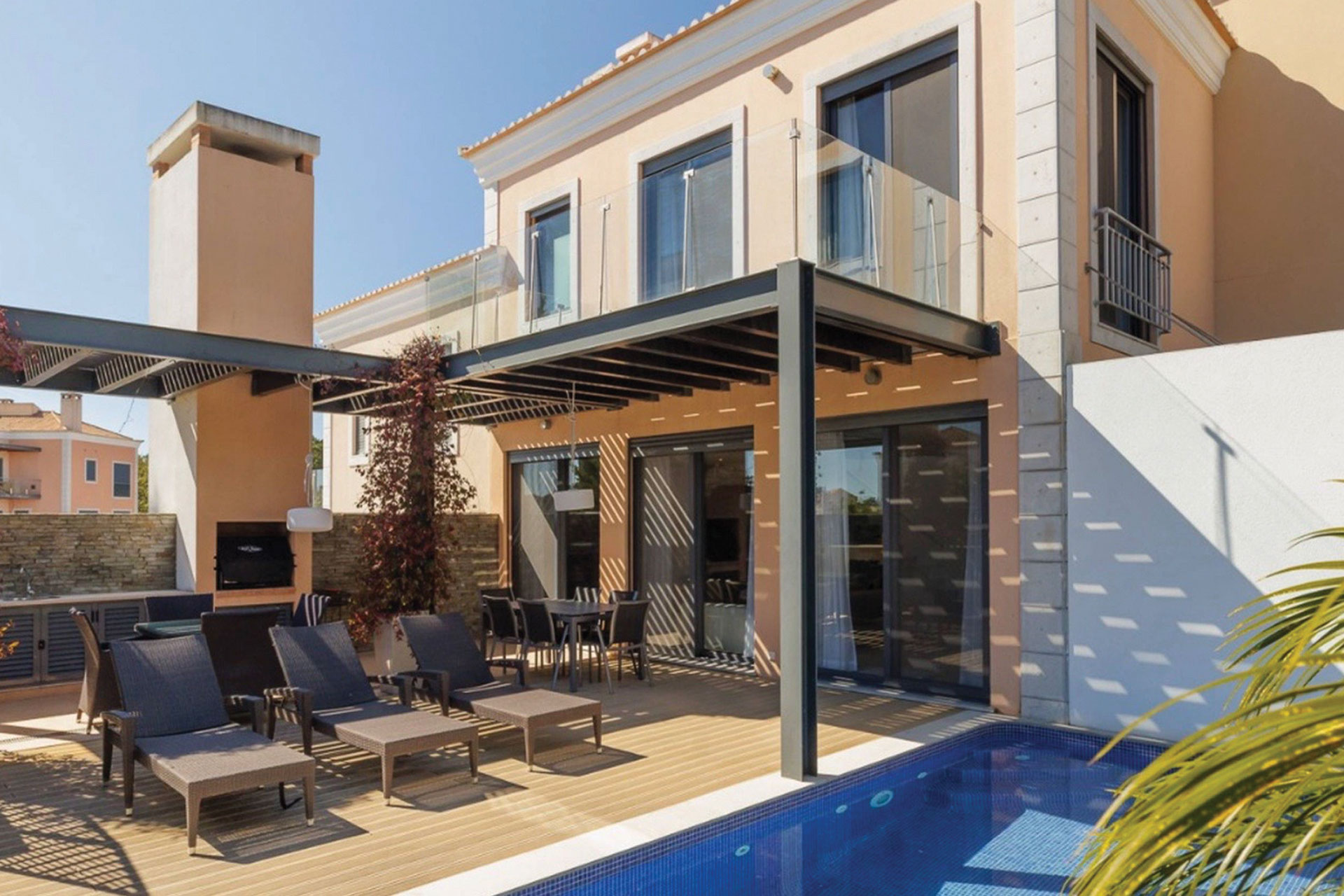 Portugal villa with outdoor pool and sunloungers.