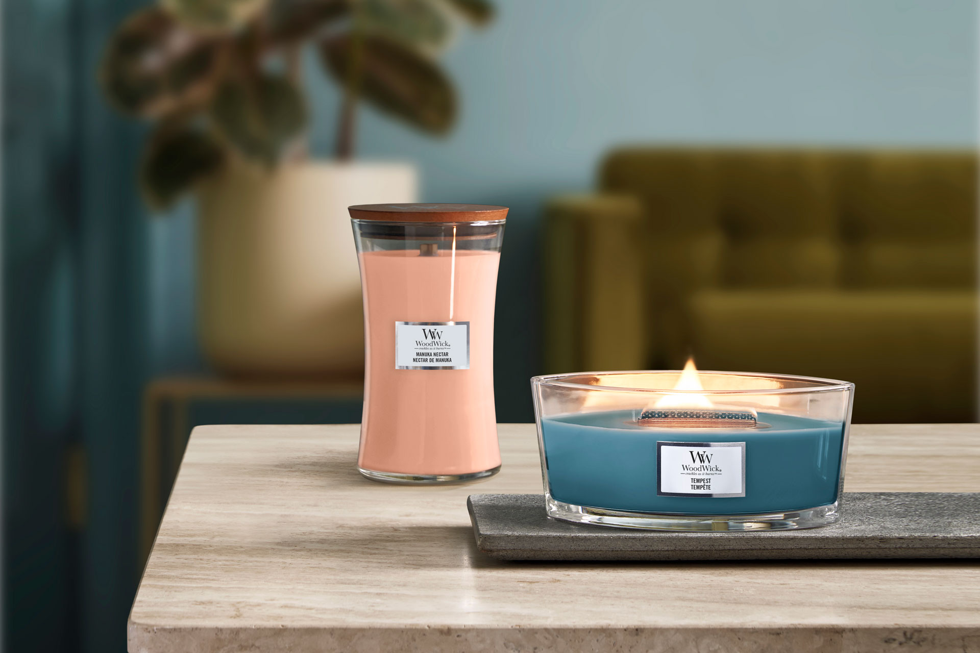 Pink hourglass-shaped candle and large blue circular candle.
