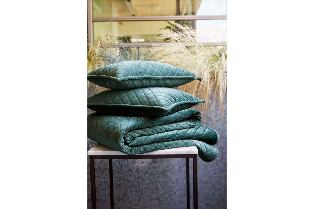 green cushions and a throw