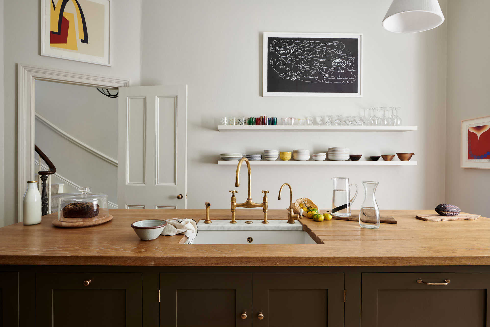 Modern kitchen with black cabinets and oak worktops.