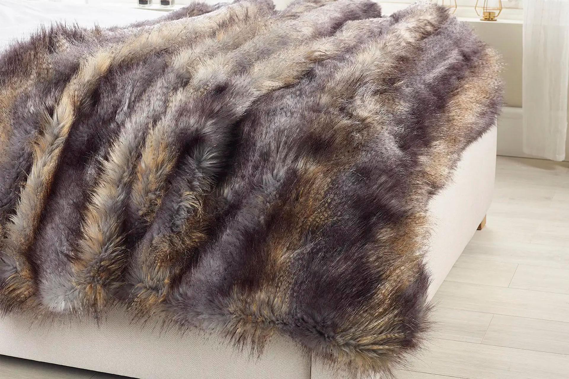 Faux fur throw on white divan bed.