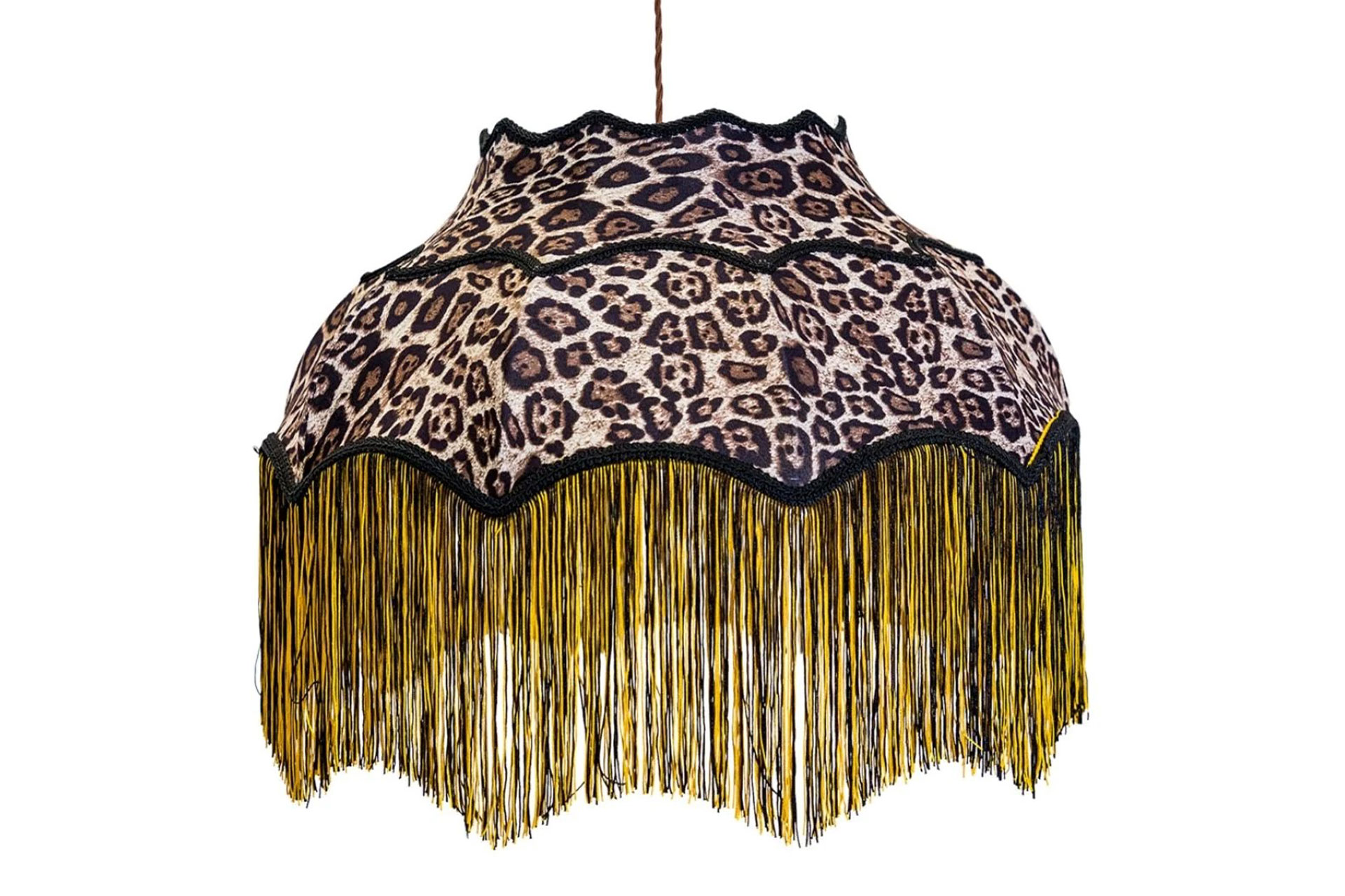 Leopard print lampshade with black trim and gold fringing.