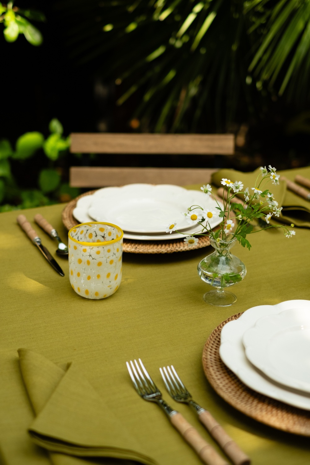 Table laid with green tablecloth