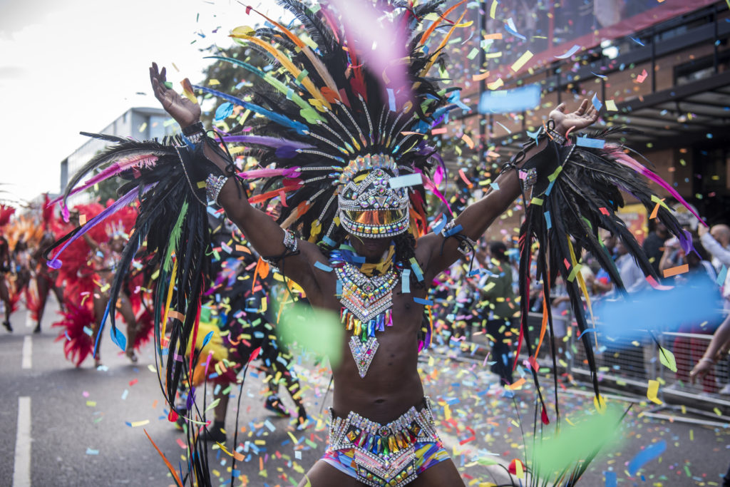 Confetti and a vibrant costume at Hackney Carnival