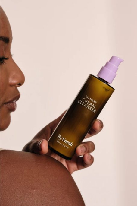 Woman holding bottle on her shoulder