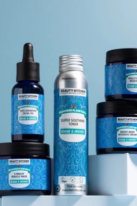 Blue bottles of product from British B Corp beauty brand Beauty Kitchen