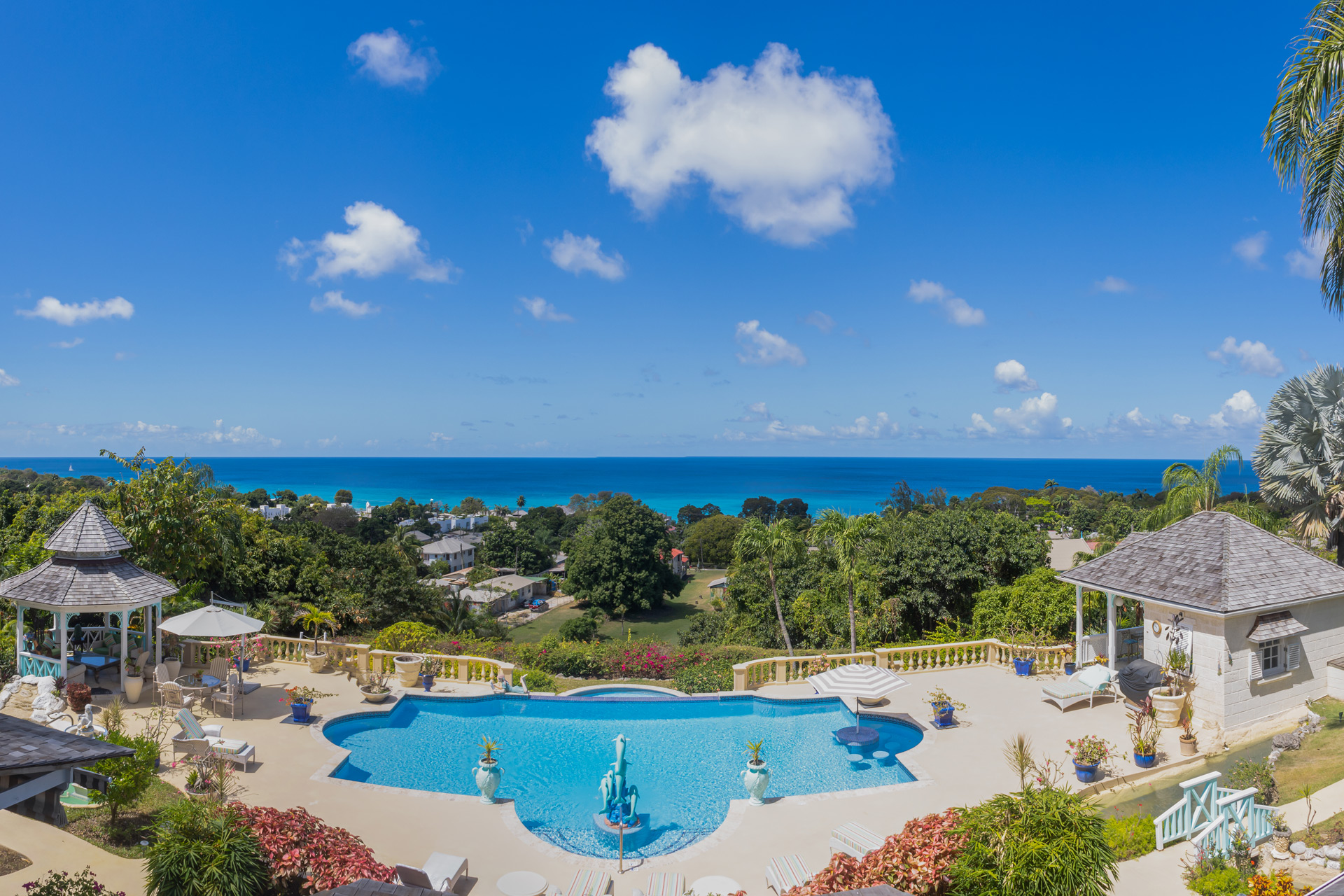 Garden with swimming pool, poolhouse and views of the Caribbean Sea.