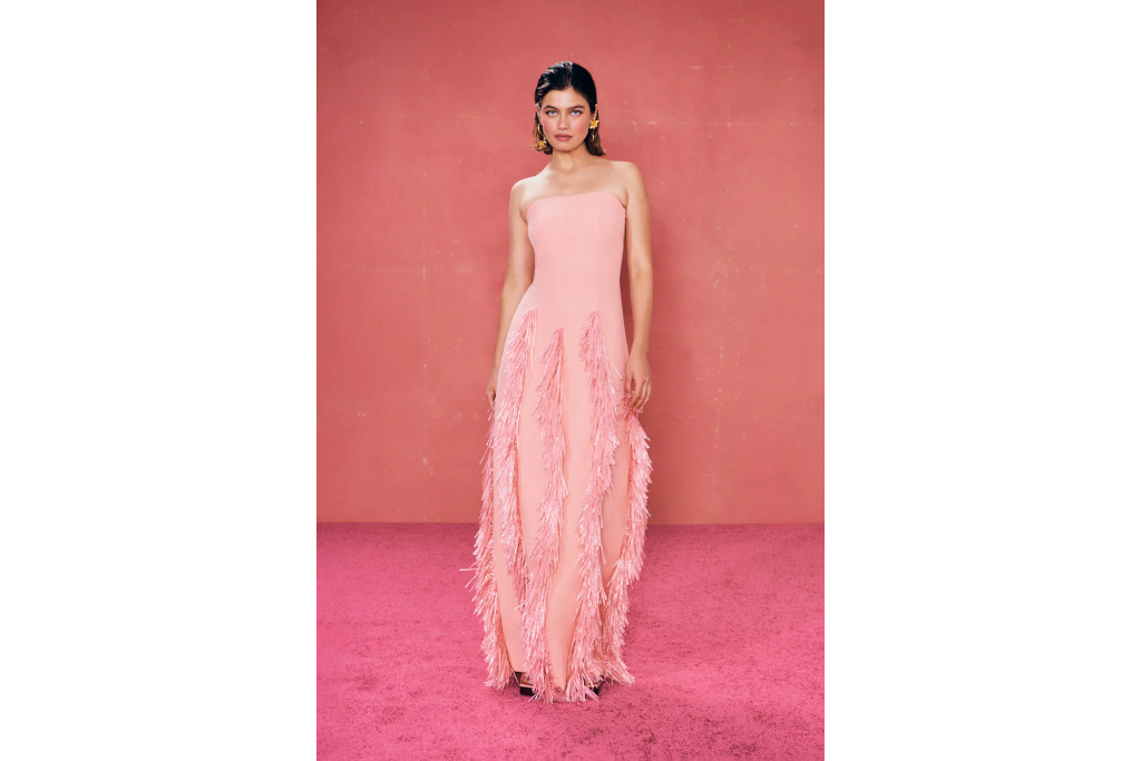 Woman in pink wedding guest dress