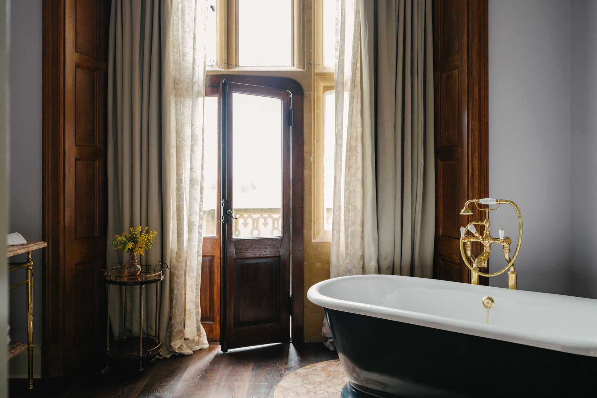 Estelle Manor suite bathroom with freestanding claw-foot bathtub